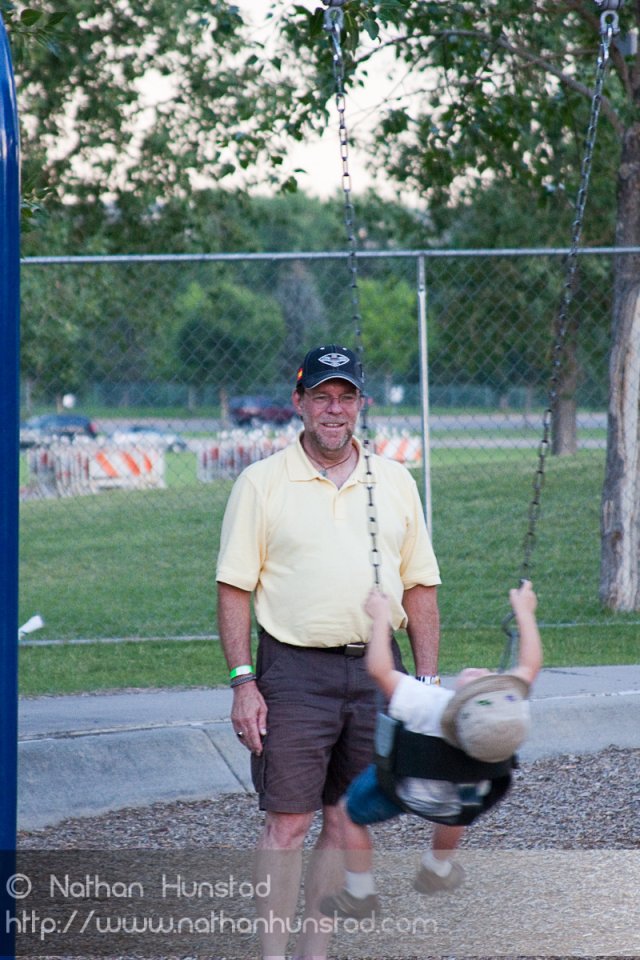John Miller and Michael Weber playing on the swings at the Colorado Irish Festival